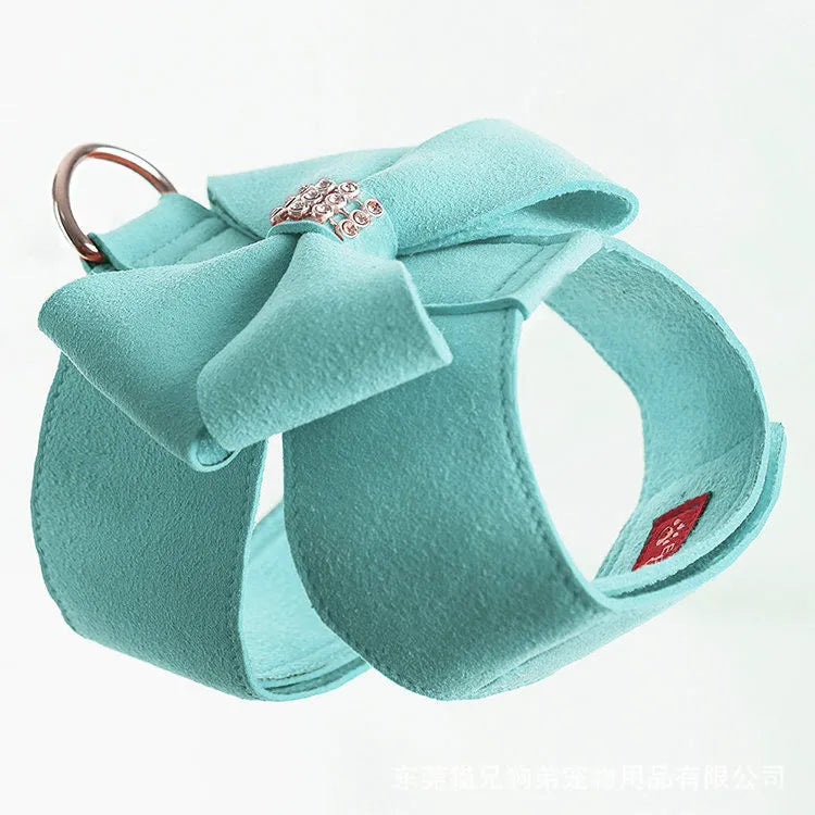 A pink microfiber dog chest strap with a decorative bow, sized for a small puppy.