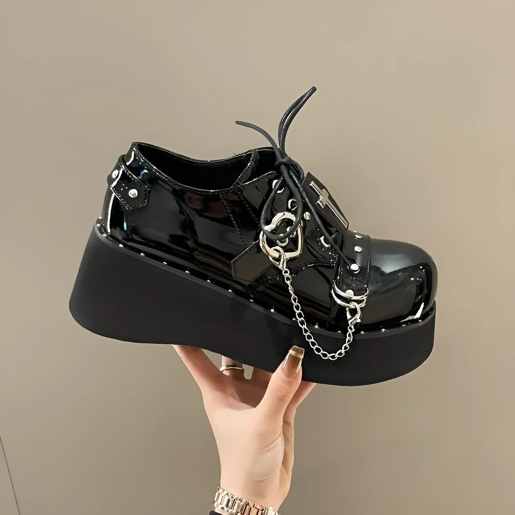 Solid black punk platform shoes with leather upper, rubber sole, and visible stitching detail