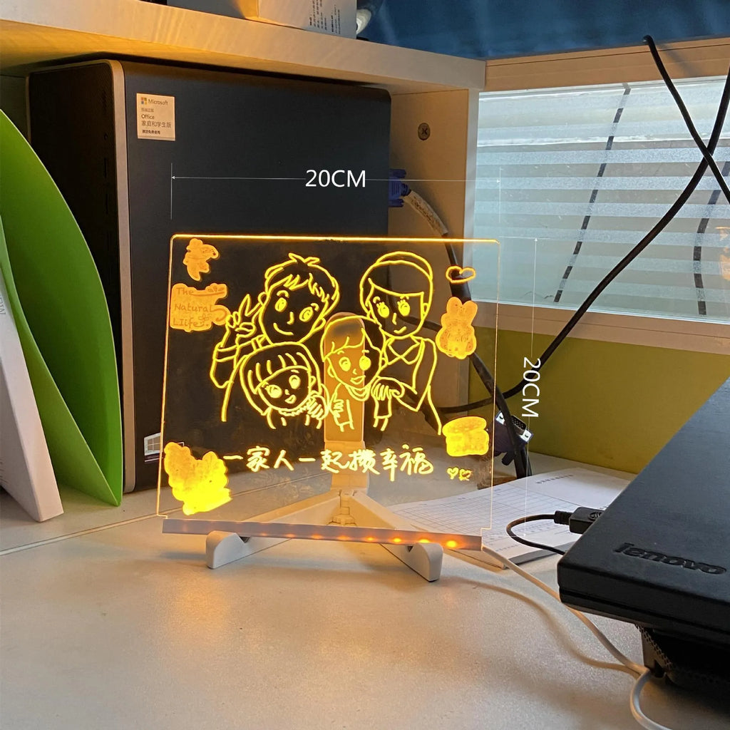 DIY acrylic LED message board on a desk with handwritten notes, glowing softly, next to colourful pens.