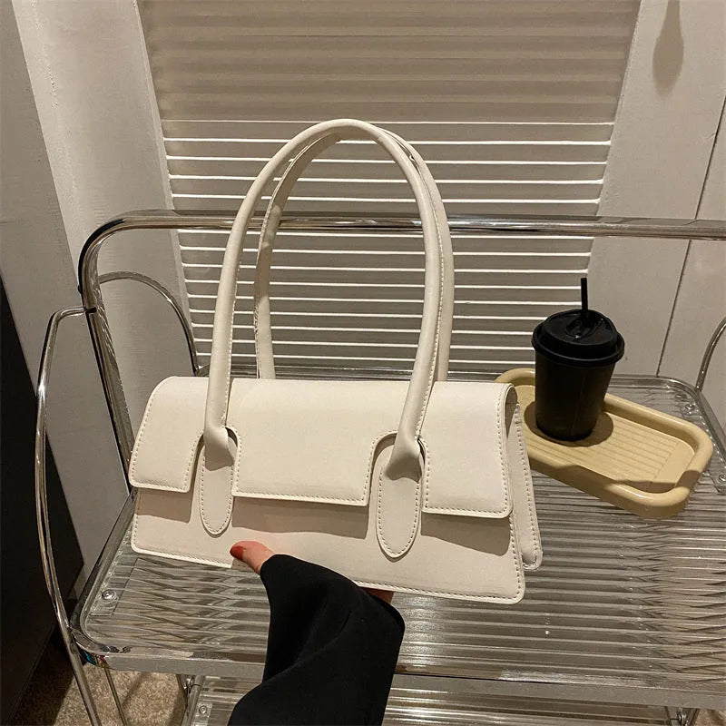 Women's black PU small square shoulder bag with single strap and stitching details