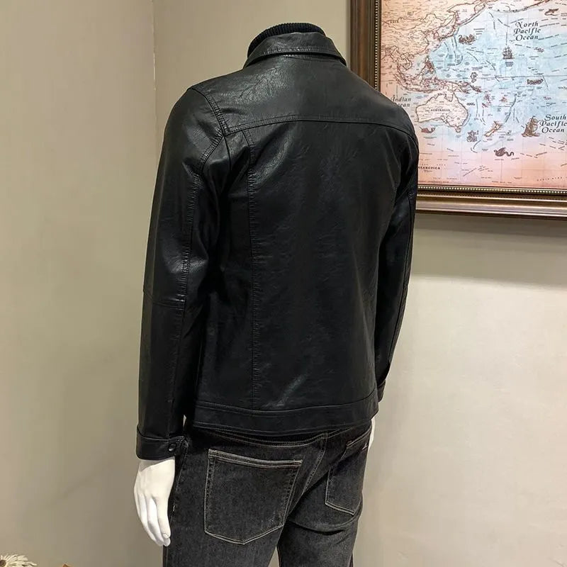 Front view of a black men's artificial leather biker jacket with loose fit, medium length, on a neutral background