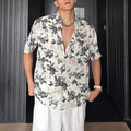 Women's loose-fit floral print short sleeve shirt in white, shown with a cardigan-style button front.