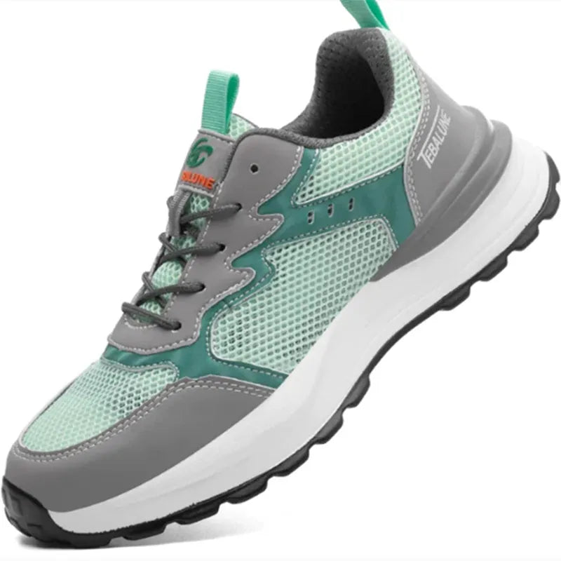 Green low-top work shoes with mesh upper, plastic steel toe cap, and slipper-style closure on a white background.