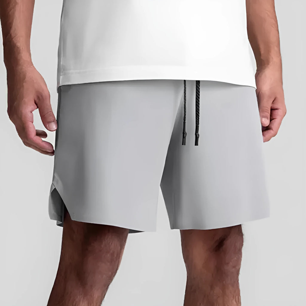 Men's grey seamless polyester sports shorts with elastic waist, shown front and back.