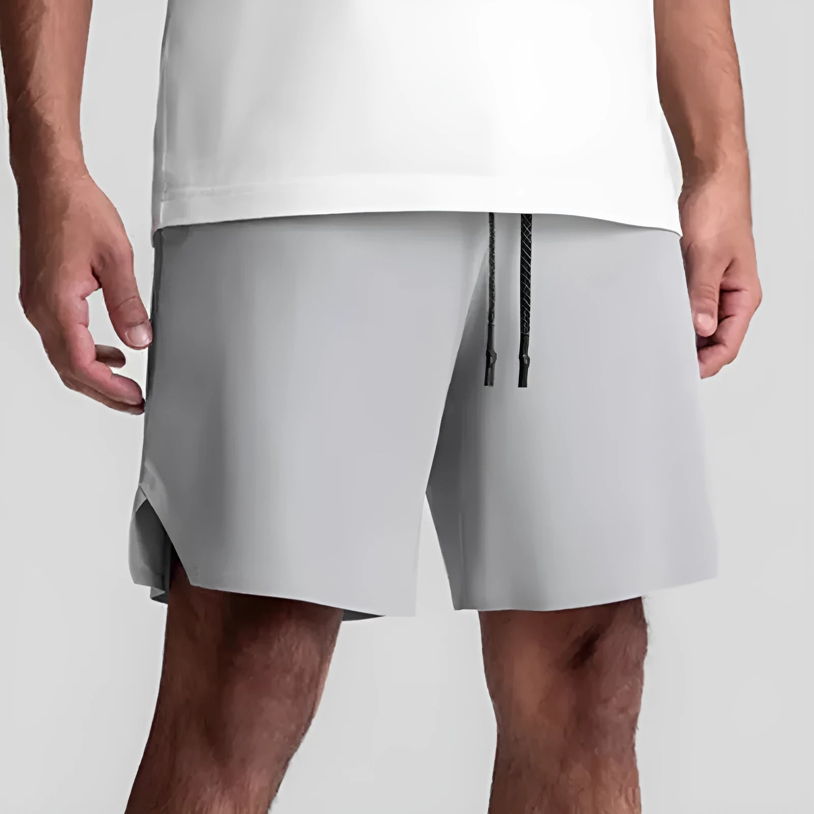 Men's grey seamless polyester sports shorts with elastic waist, shown front and back.