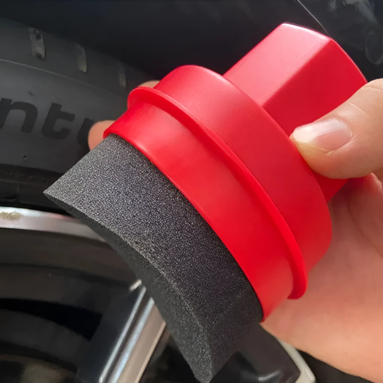 Black car tyre polishing sponge brush with lid on a clean tyre, showing ergonomic PP handle and applicator head.