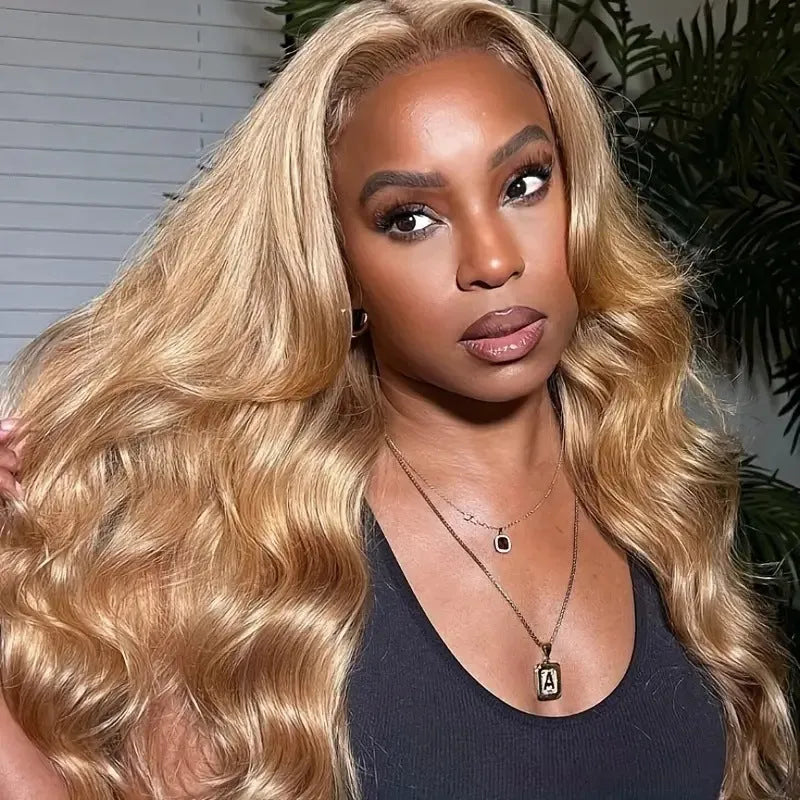 Long light brown curly wig with golden big waves and side bangs on a mannequin head.
