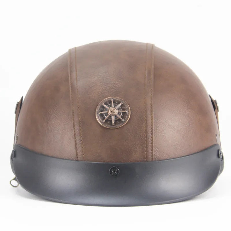 Retro black leather motorcycle helmet with a half-visor on a background.