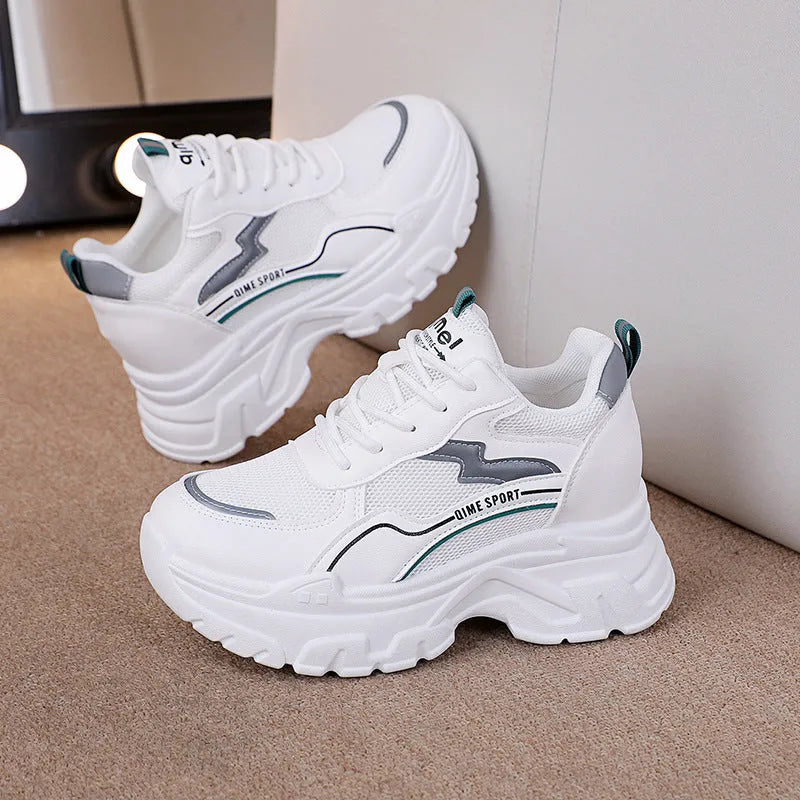Women's white breathable dad shoes with cross strap and lace-up front on a rubber sole.