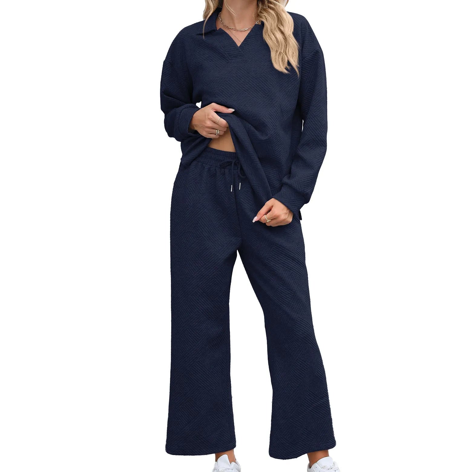 Women's black geometric pattern knitted jacquard suit with long sleeve sweater and elastic waist cropped trousers.