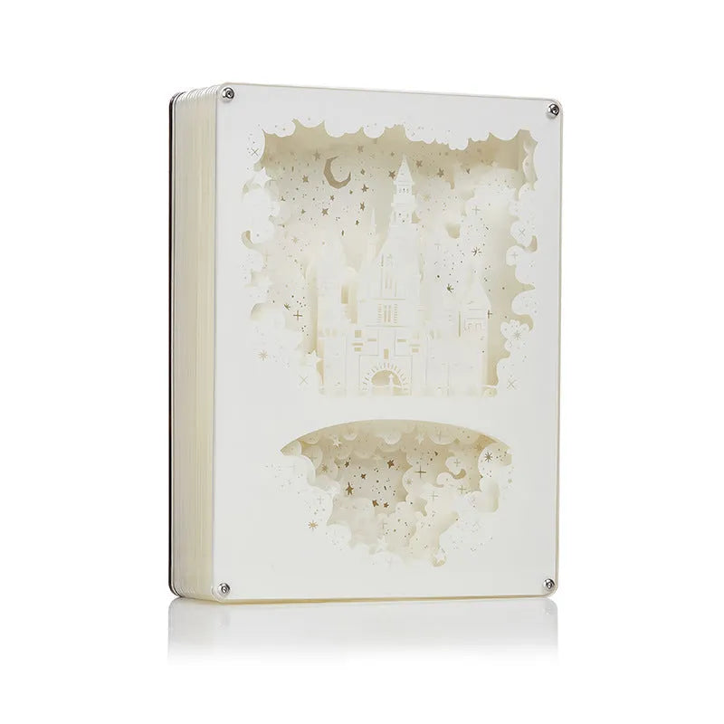 Modern bedside USB night light with 3D carved plastic shade and remote control on a table.