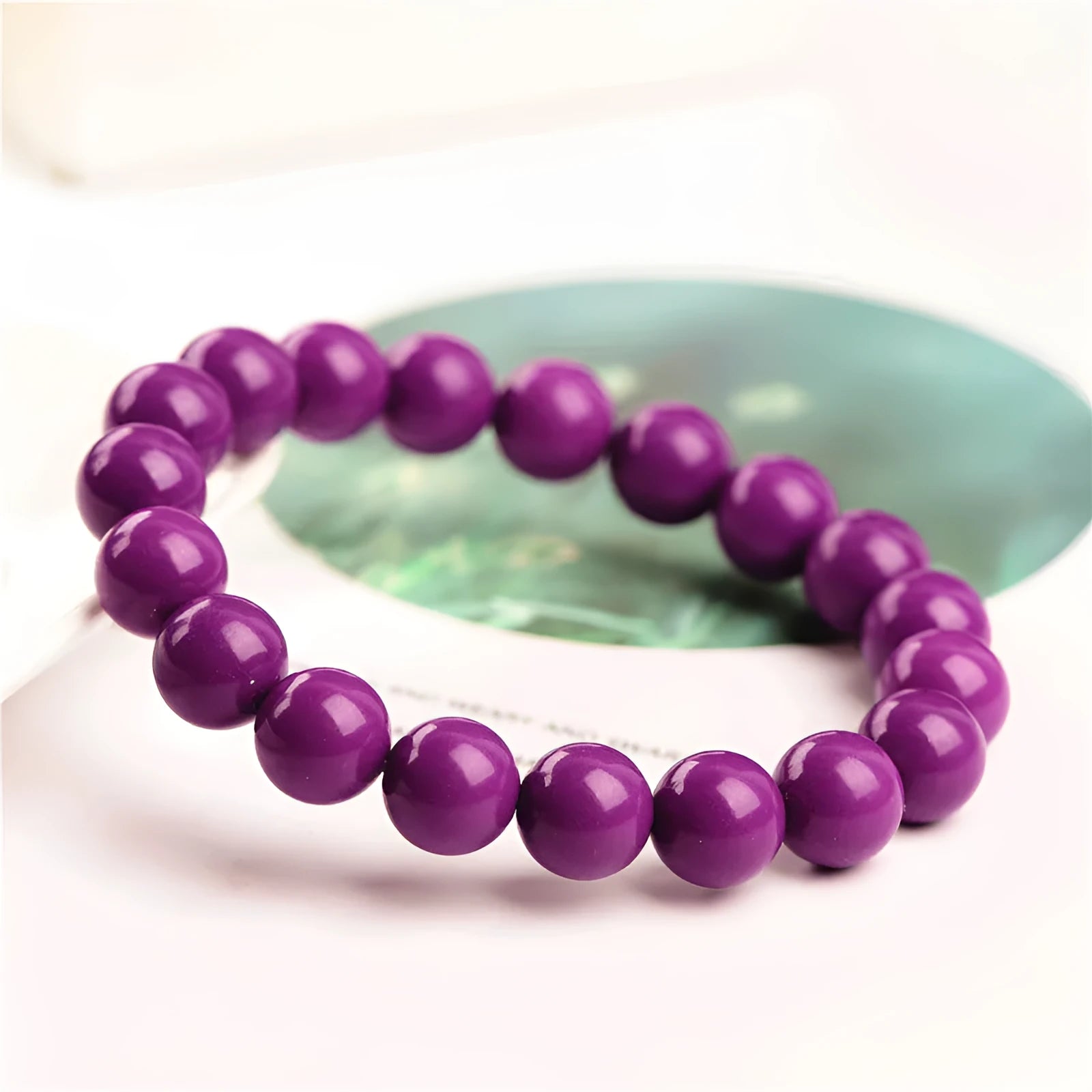 Purple mica crystal bracelet with polished beads, shown in unisex design.