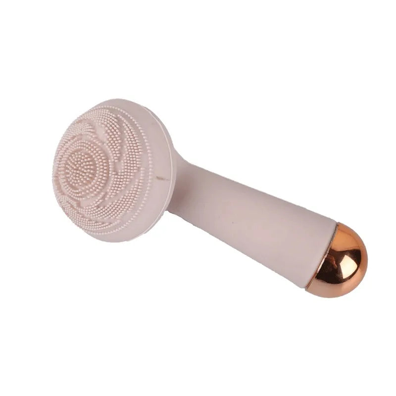 Electric face wash cleaner with pink silicone brush head on a light background