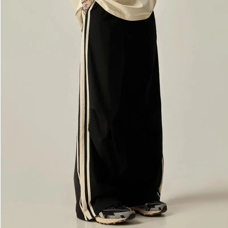 Black men's wide-leg climbing trousers with a high waist on a hanger.