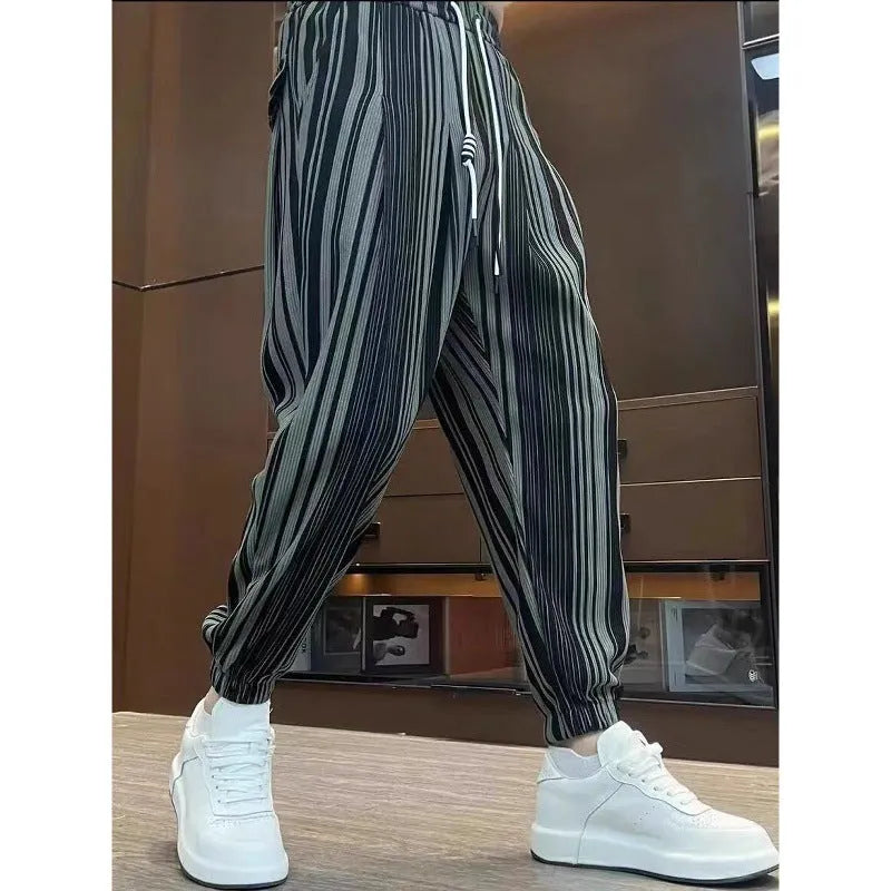 Men's cropped ankle-tied ice silk pants in dark gray stripe pattern, front view on model