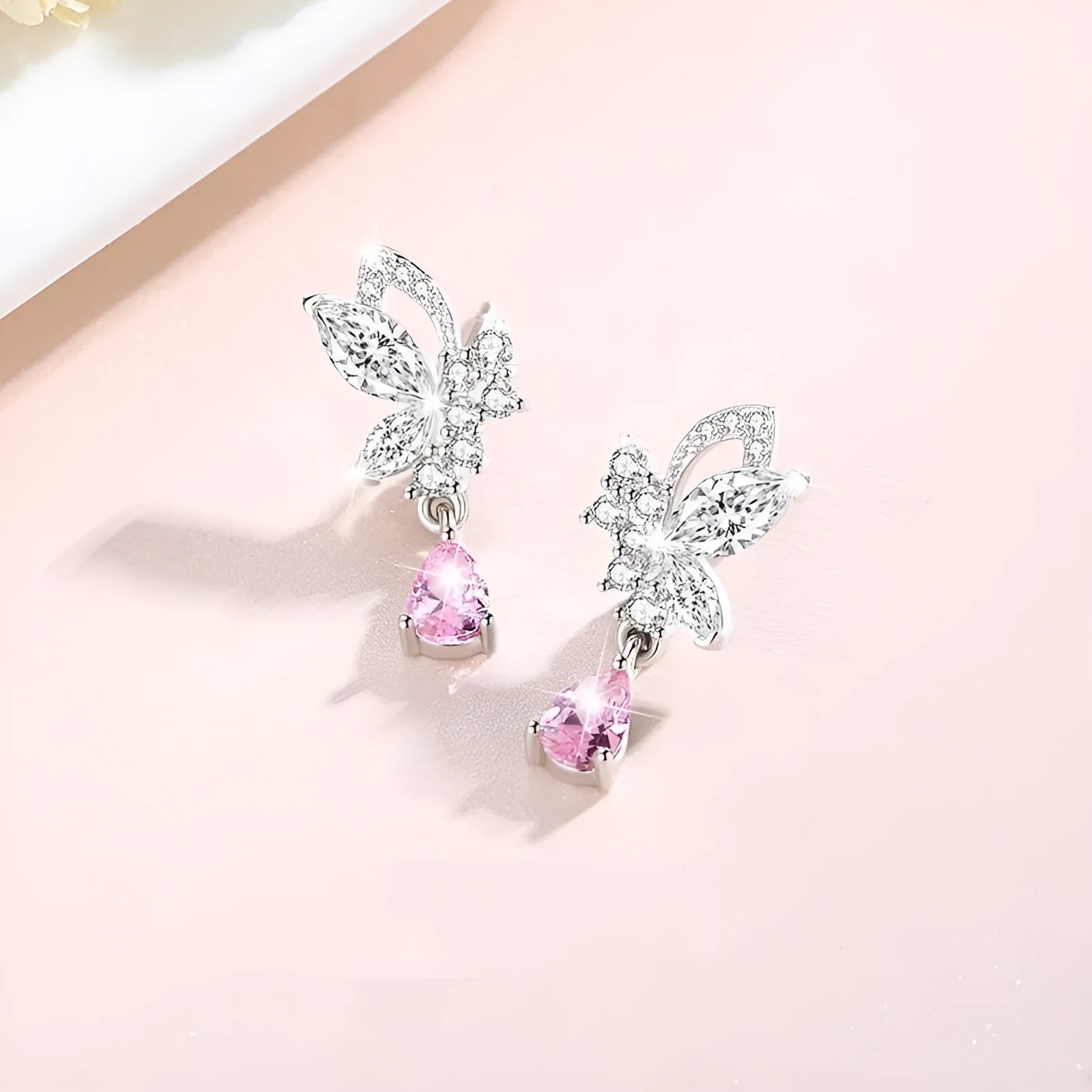 Women's sterling silver butterfly stud earrings with crystal accents on white background
