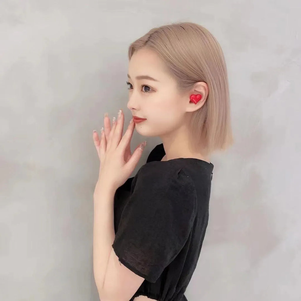 Heart-shaped wireless Bluetooth earphones in Chinese red and girl pink colours with charging cable