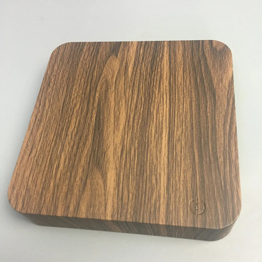 Square walnut coloured levitating moon lamp with galaxy light effect rotating above a circular base.