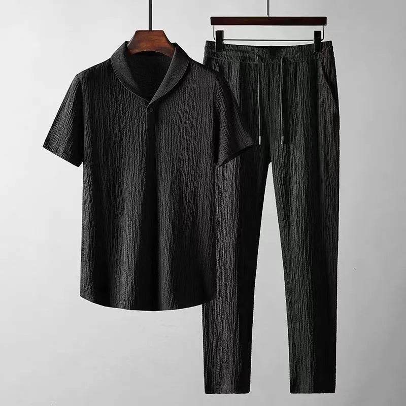 Men's summer leisure suit with loose short sleeve top and drawstring trousers in black or white polyester