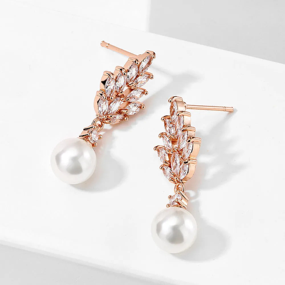 Geometric floral design earrings with micro inlaid zircon detail in gold, platinum, and rose gold finishes.