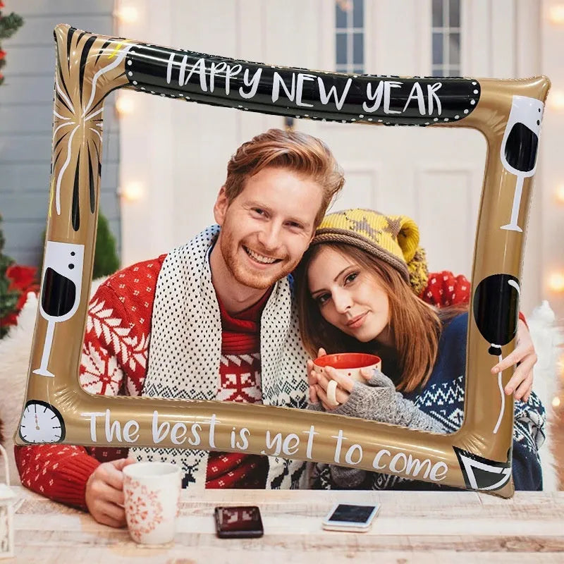 Red and green Christmas-themed inflatable photo frame held by a person.