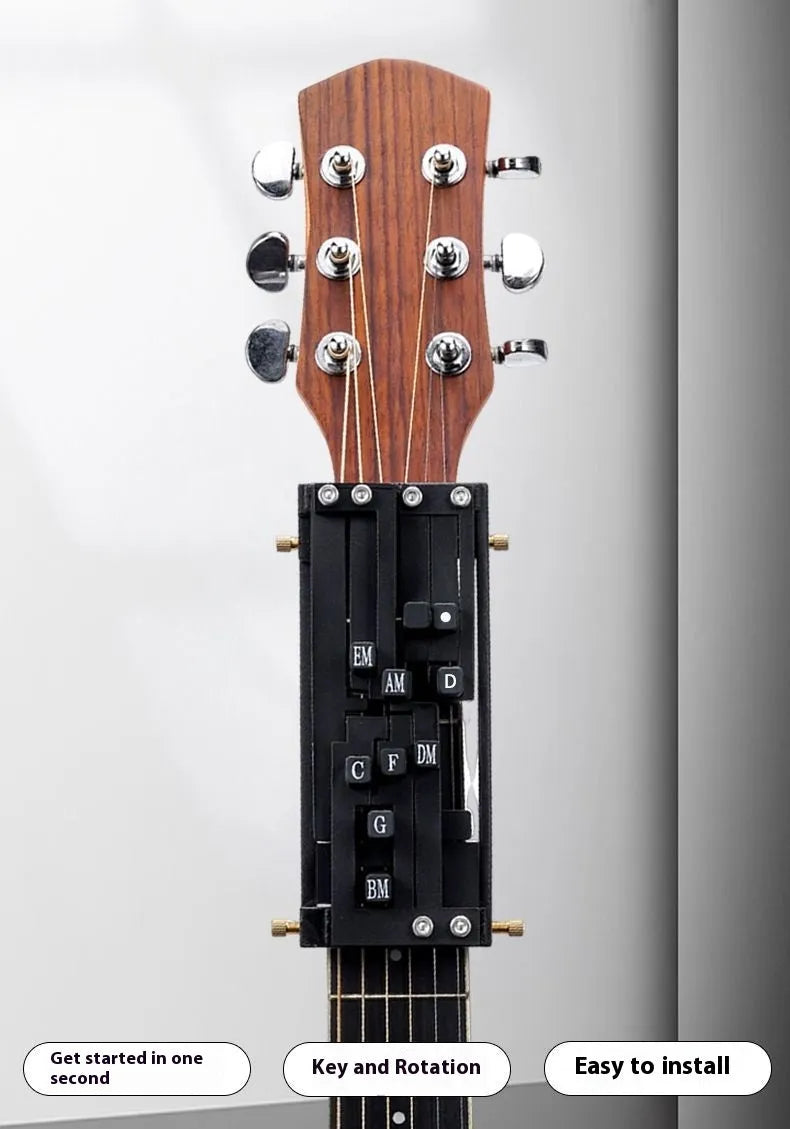 Black automatic chord device for folk guitar, showing the auxiliary gear mechanism for novice practice.