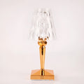 Rose gold plated portable touch night light with acrylic body on a surface.