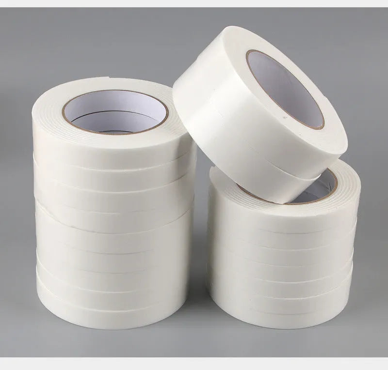 Roll of white foam double-sided adhesive tape showing its 3mm thickness and strong adhesive.