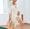 Apricot crocheted patchwork dress on a hanger showing regular sleeves and midi length.