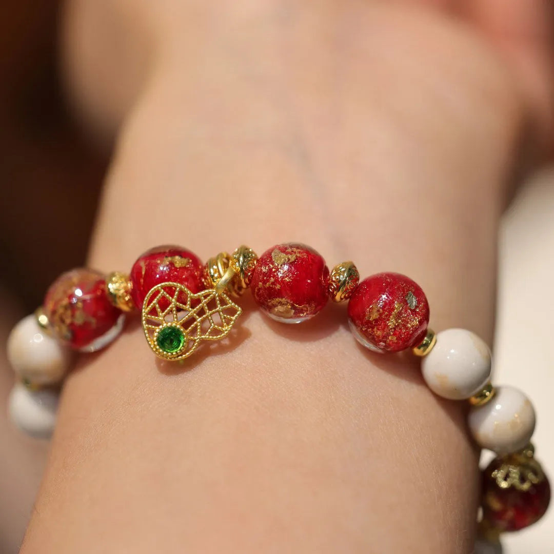 Women's ethnic geometric bracelet with gold foil decoration on glass and coloured glaze in two colour options.