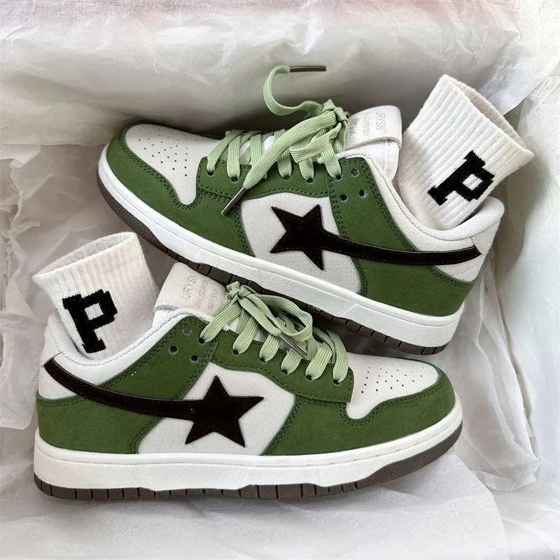 Women's retro green lace-up board shoes with round toe and flat rubber sole on a plain background