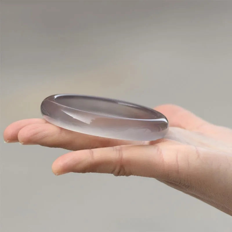 Dark grey Brazilian iced chalcedony agate bracelet with natural pattern, shown on a wrist.