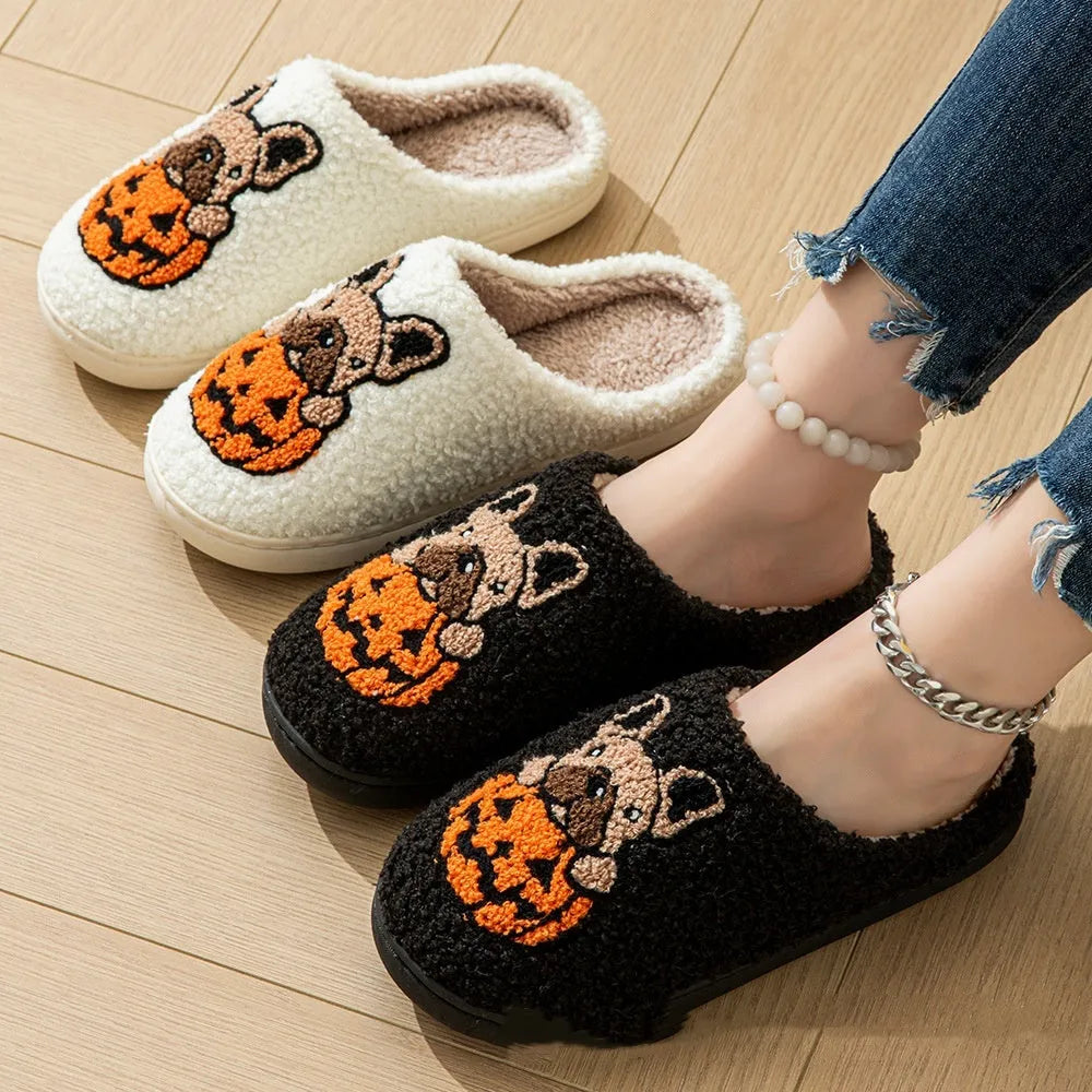 Black and white plush Halloween slippers with pumpkin pattern, round toe, and textured TPR sole.