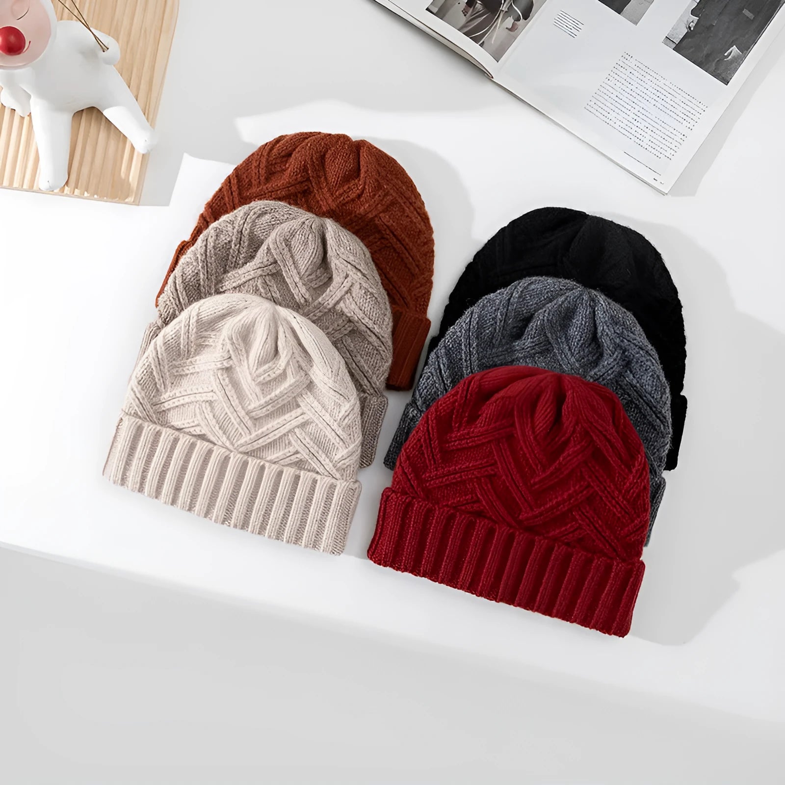 Woman wearing a knitted wool beanie with a dome crown and tribal totem pattern in Ankela Red.