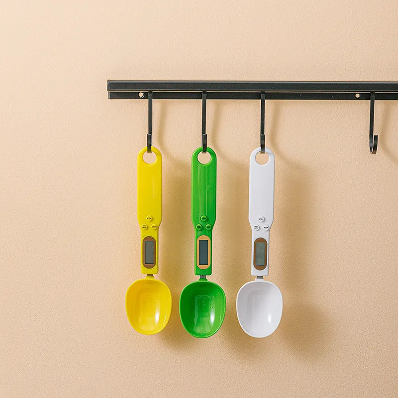 White digital kitchen spoon scale with LCD display showing weight measurement