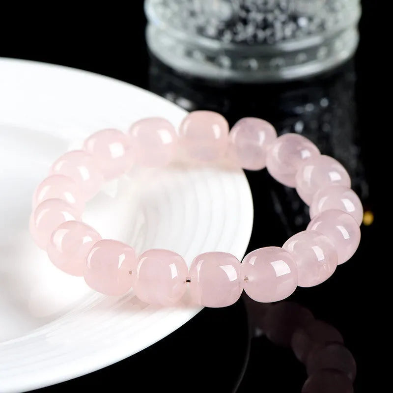 Pink crystal bamboo bracelet with 11x12mm geometric barrel beads on a wrist.