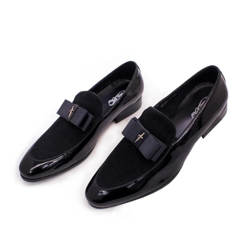 Men's black tassel loafer shoe with matte leather and glossy patent leather detail on a white background.