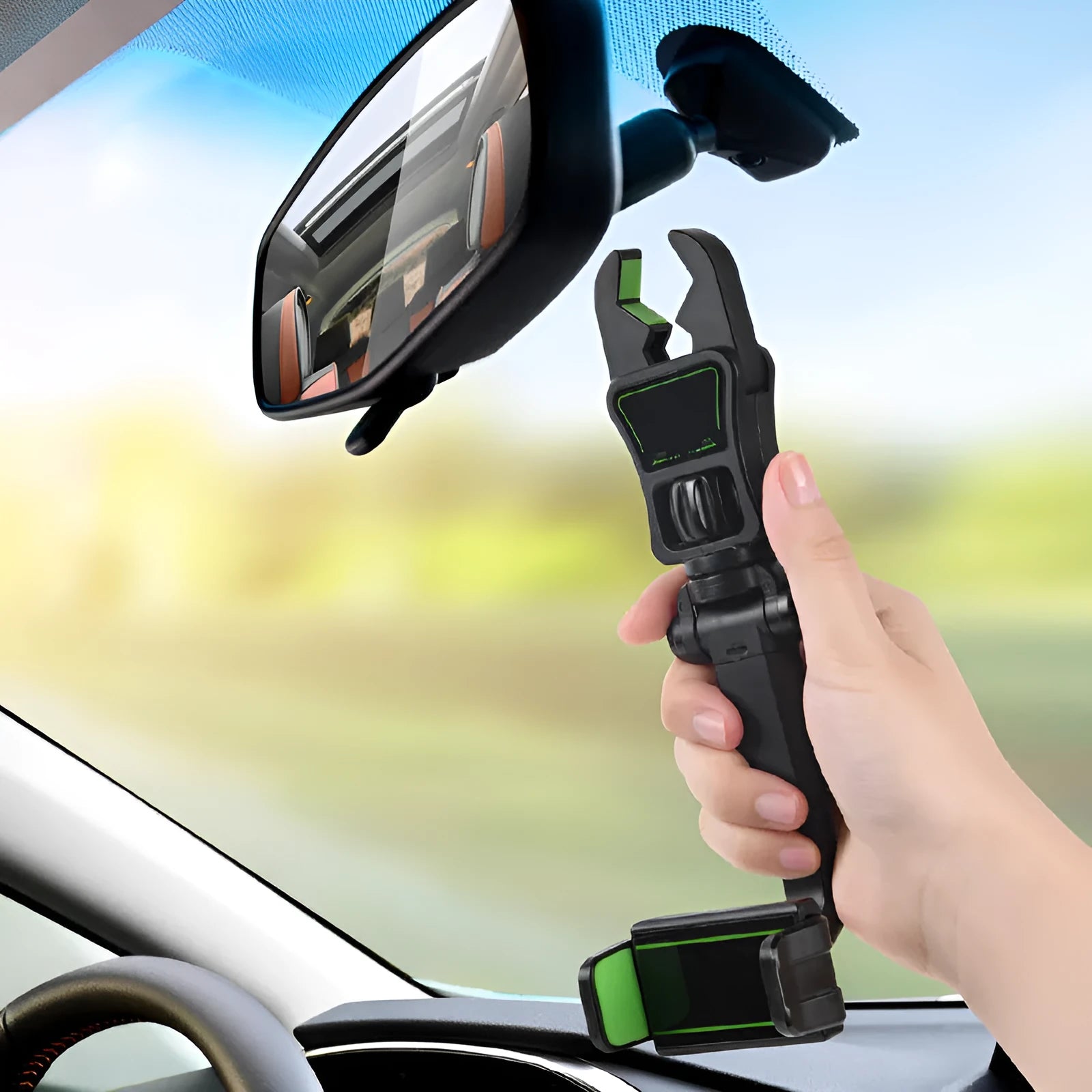 Black and green car mobile phone holder mounted on a rear-view mirror bracket.