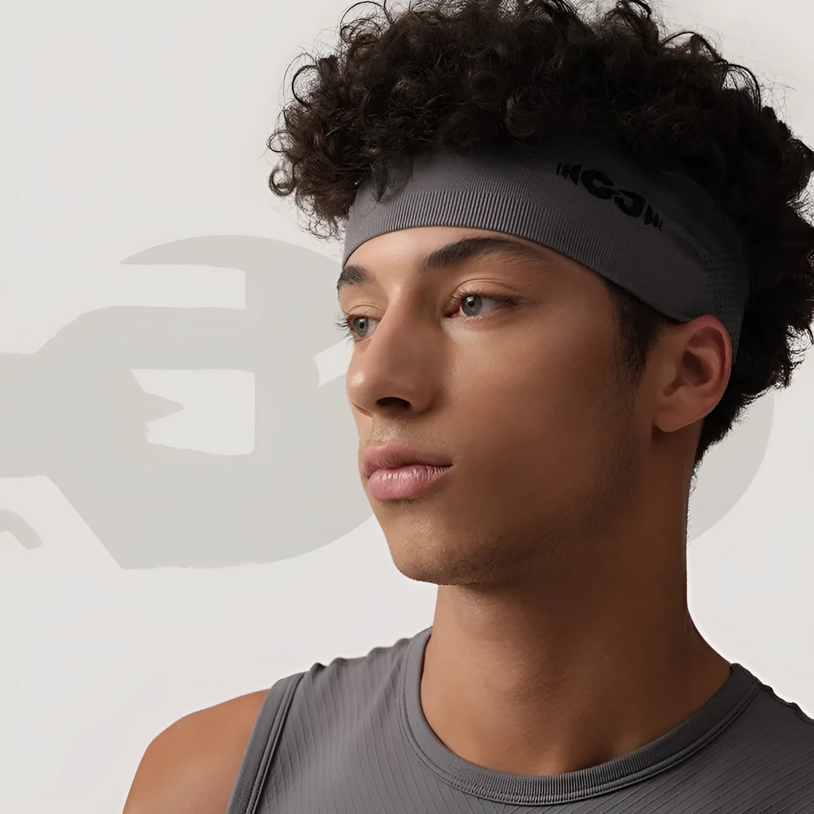 A seamless knitted exercise hair band in black, shown on a person during outdoor activity.
