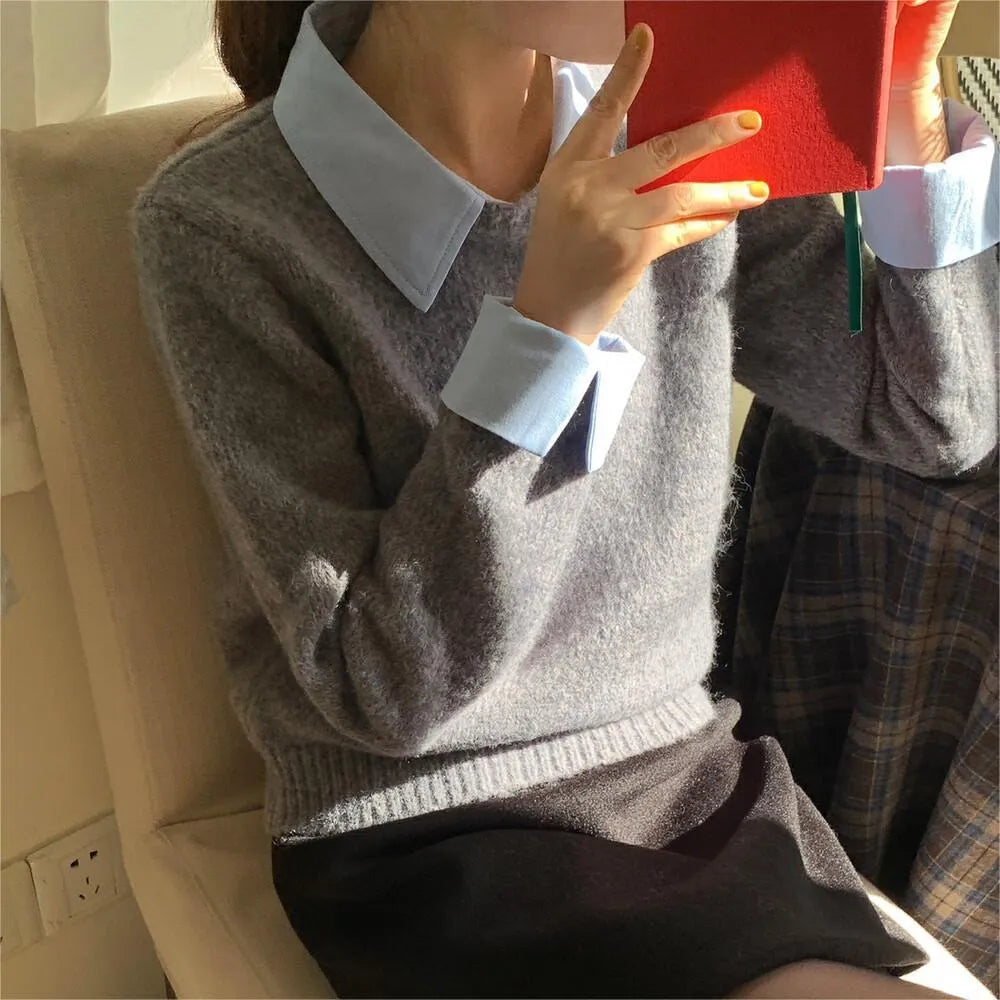Women's loose knitwear top in navy blue with long sleeves and solid colour design