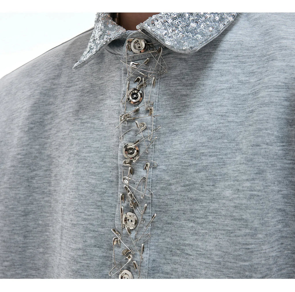Loose fit black sequined shirt with a square neckline, short sleeves, and metal decoration details.