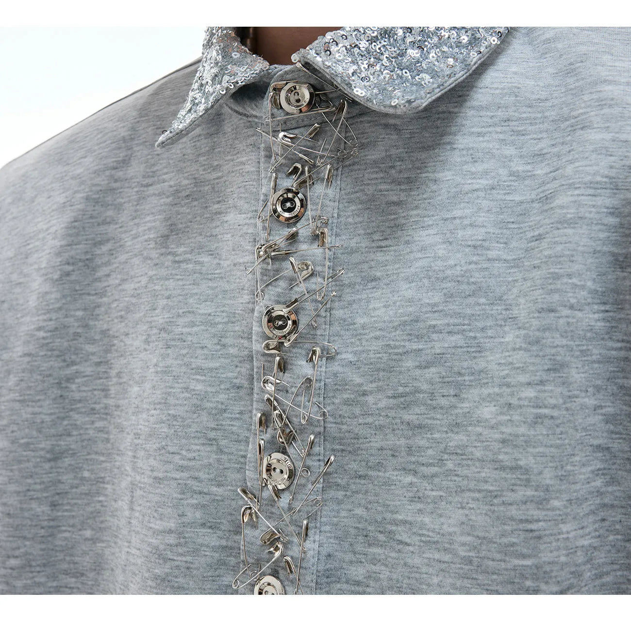 Loose fit black sequined shirt with a square neckline, short sleeves, and metal decoration details.
