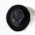Handmade grey wool felt conical hat with a black embroidered skull design on the front.