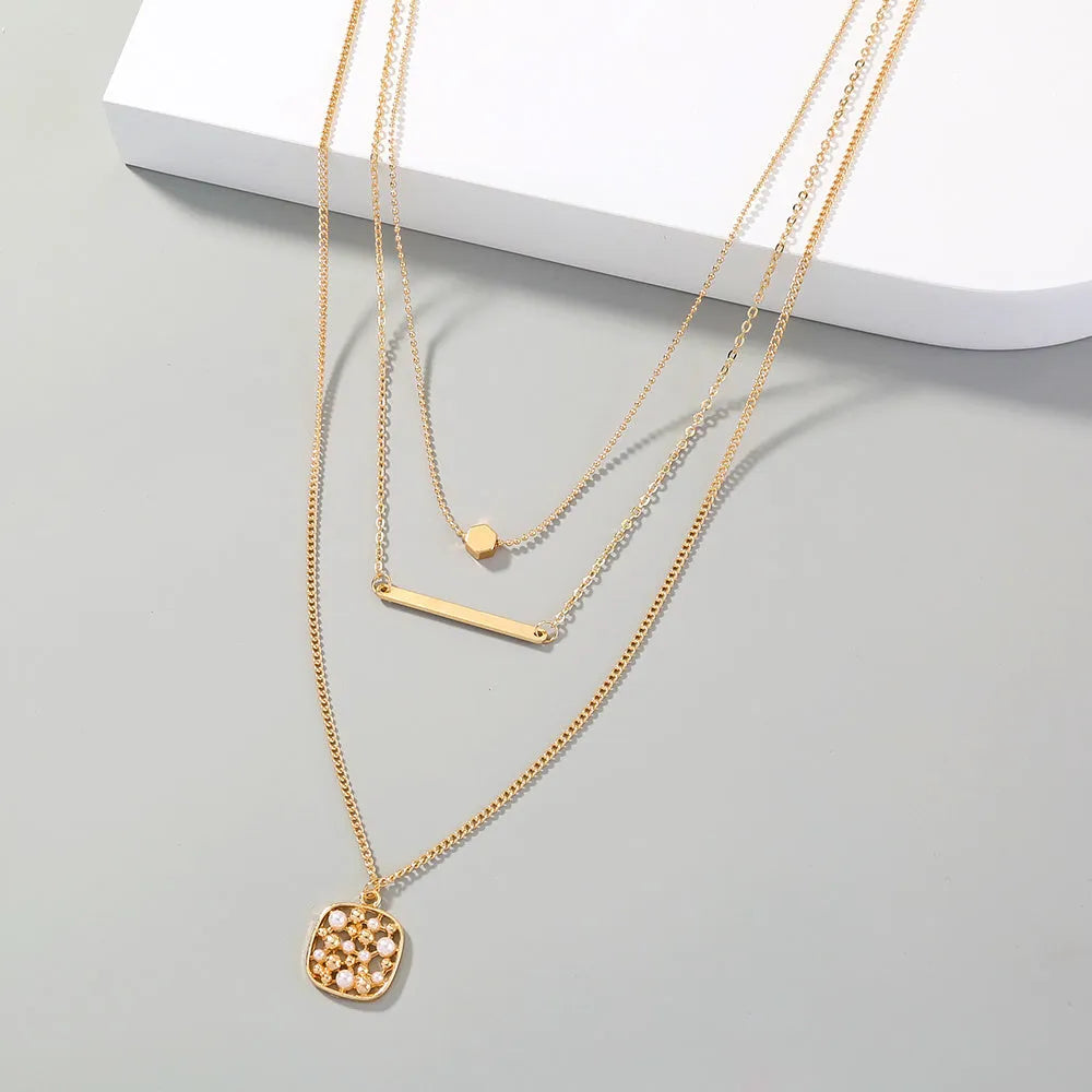Multi-layer gold necklace with geometric pineapple pendant on adjustable chain, electroplated finish, zinc alloy