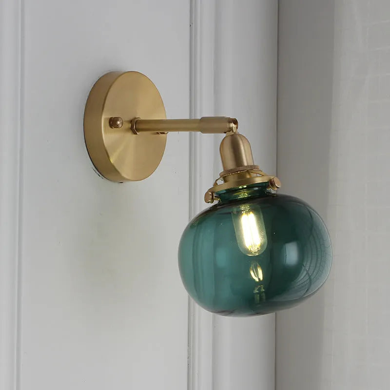 Creative pumpkin-shaped wall lamp with a textured water ripple glass shade mounted on a white wall