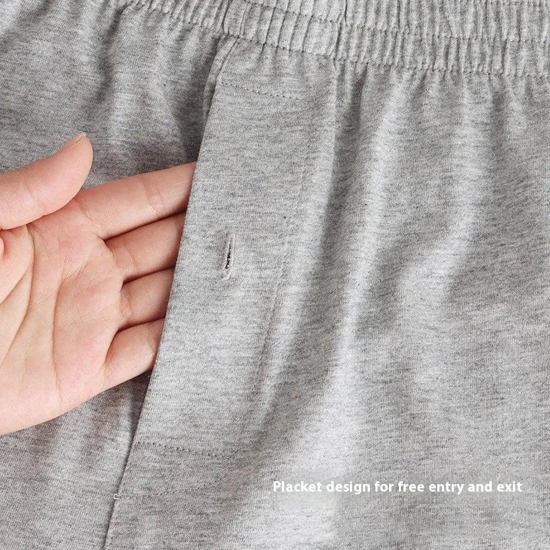 Men's solid colour cotton boxer shorts on a hanger, showing loose fit and high waist.
