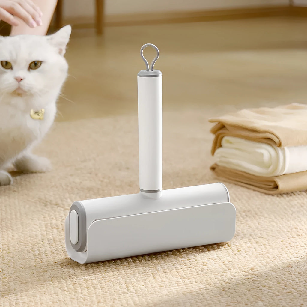 Lint remover roller with plastic handle and tearable paper roll for removing pet hair and dust.
