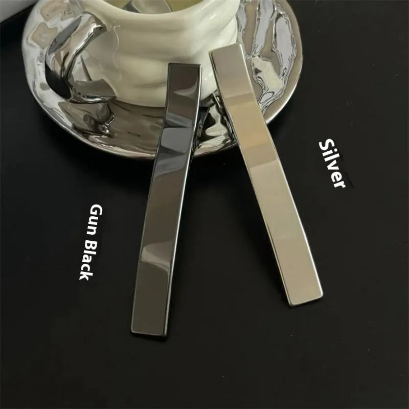Metal duckbill sub-large hair clip in silver with electroplated finish on solid background