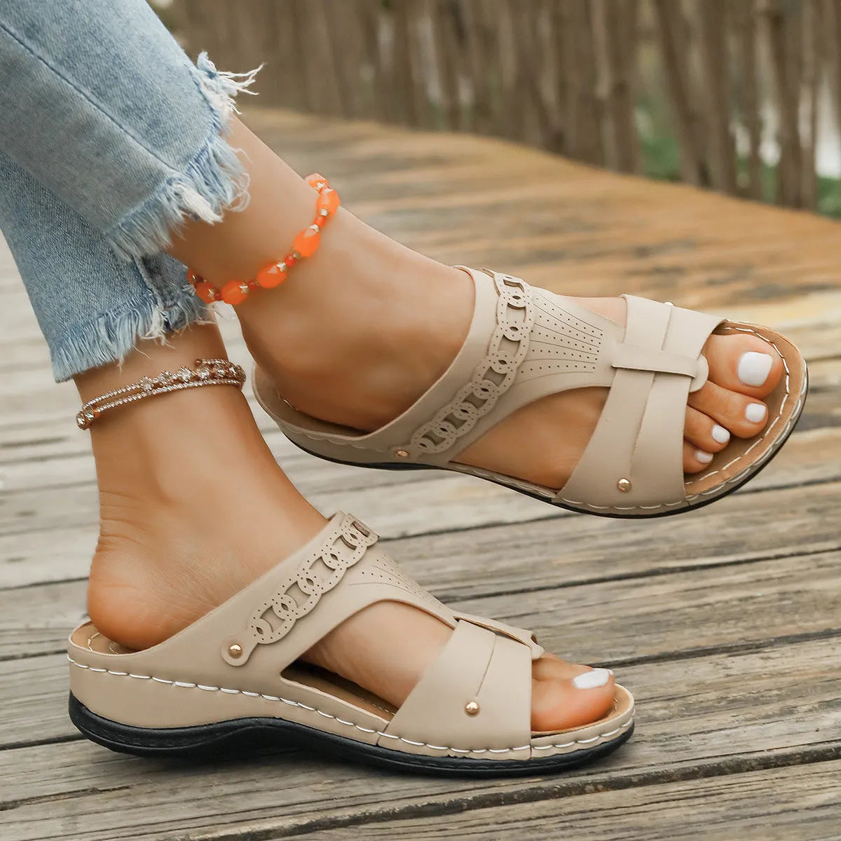 Blue Roman style casual slippers with a slope heel and fish mouth toe holder on a rubber sole.