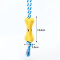 Green porous bone dog toy with rope knots for inserting treats, measuring 138x59x35mm